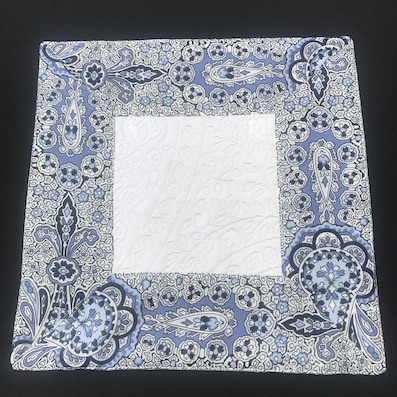 pique quilted table centre with contrasting blue border